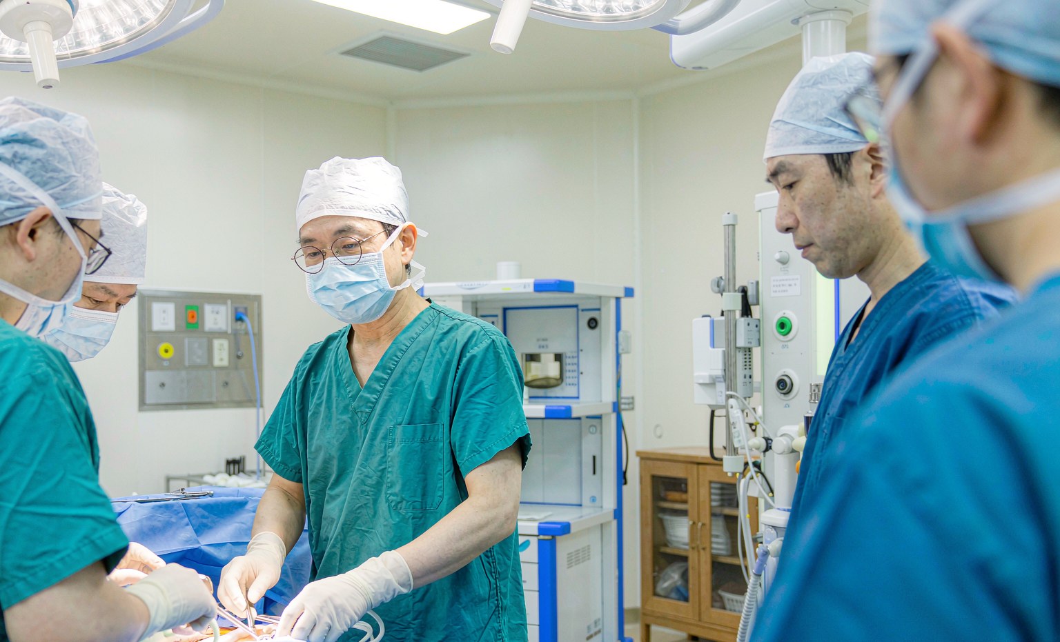 Chinese surgical team performing an operation in a modern operating room