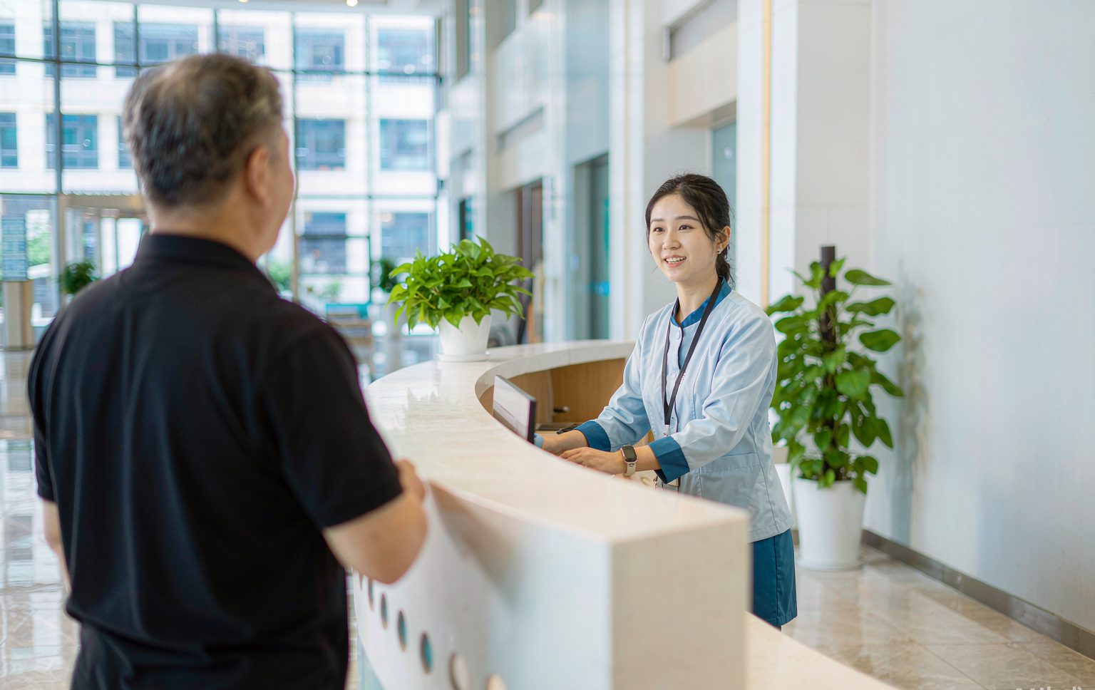 Hospital reception desk welcoming an international patient in Beijing